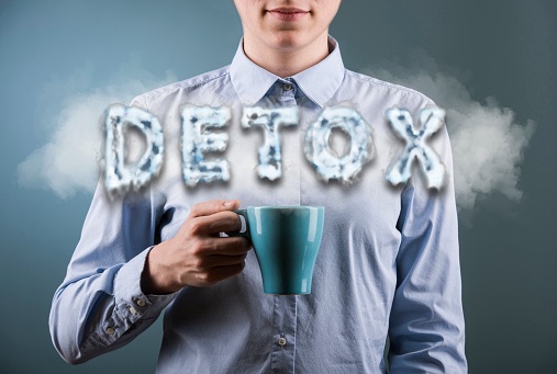 person holding cup detox