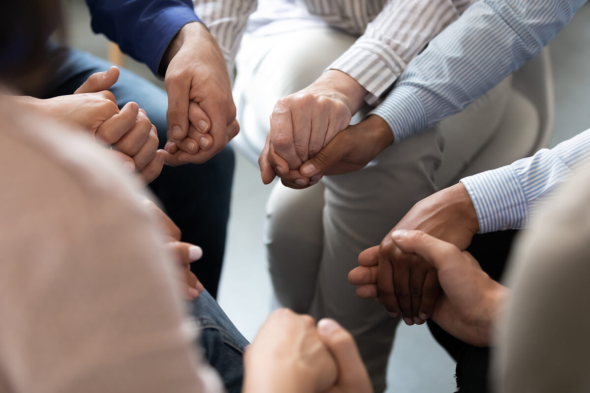 support group holding hands