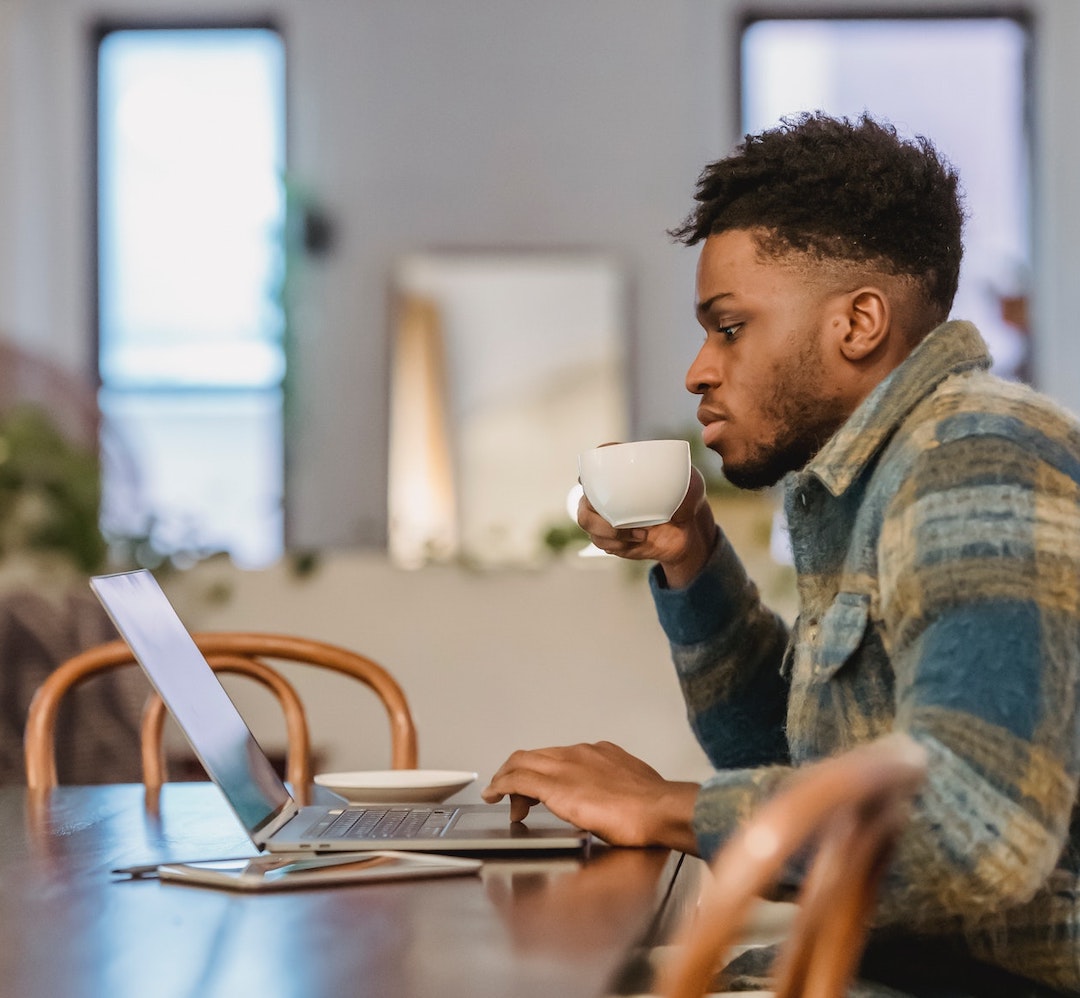 reading-laptop-coffee-pexels-andres-ayrton-6579045